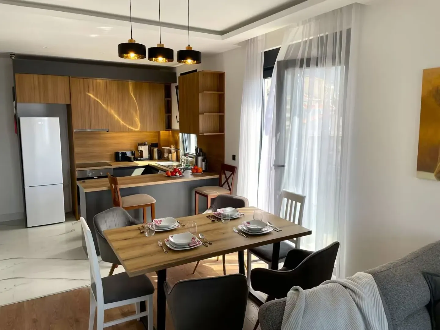 Modern kitchen with dining area and a breakfast bar in an open space.