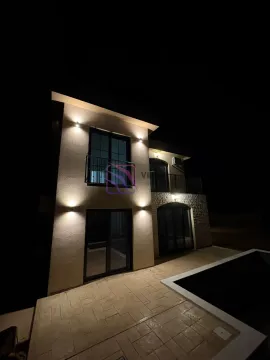 Night view of the house with illuminated facade, terraces, and a courtyard with a pool. - image 2