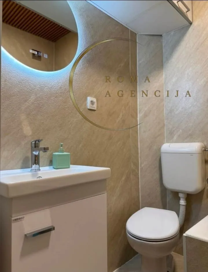 Modernly equipped bathroom with a vanity and toilet.