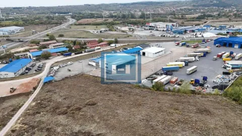 Aerial view of the complex with warehouses and parked trucks in the surrounding area. - image 14