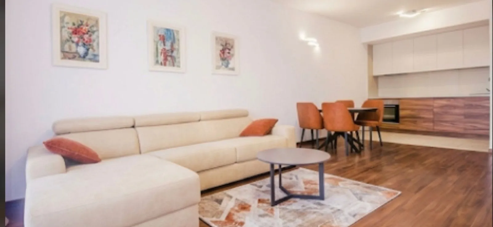 Living room with sofa connected to the dining area and kitchen.