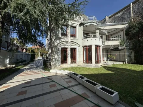 Exterior of a luxury house with a courtyard and paved pathways. - image 19