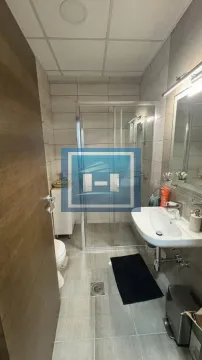 Modernly equipped bathroom with a shower cabin and a washbasin. - image 14