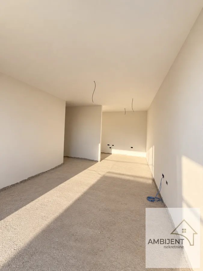 Empty room in rough construction phase with painted walls.