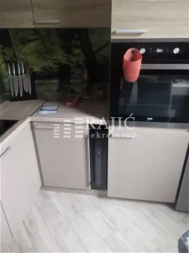 View of part of the kitchen with a built-in oven and cabinetry. - image 8