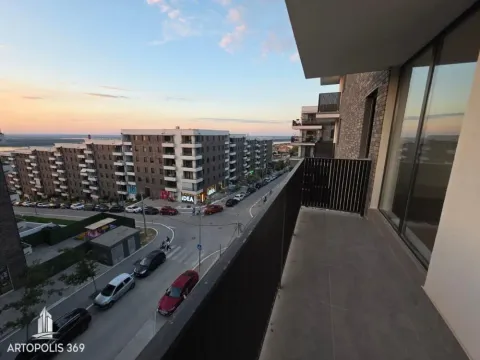 View from the balcony overlooking the city street and surrounding buildings. - image 15