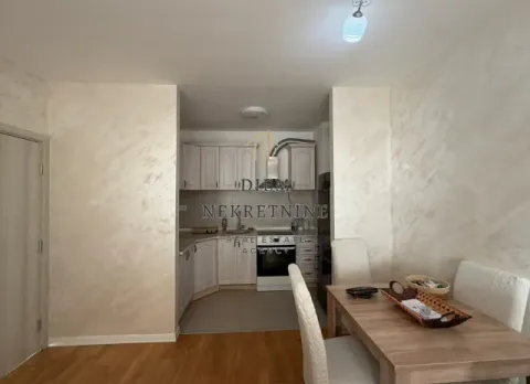 Small kitchen with a dining area within the apartment. - image 9