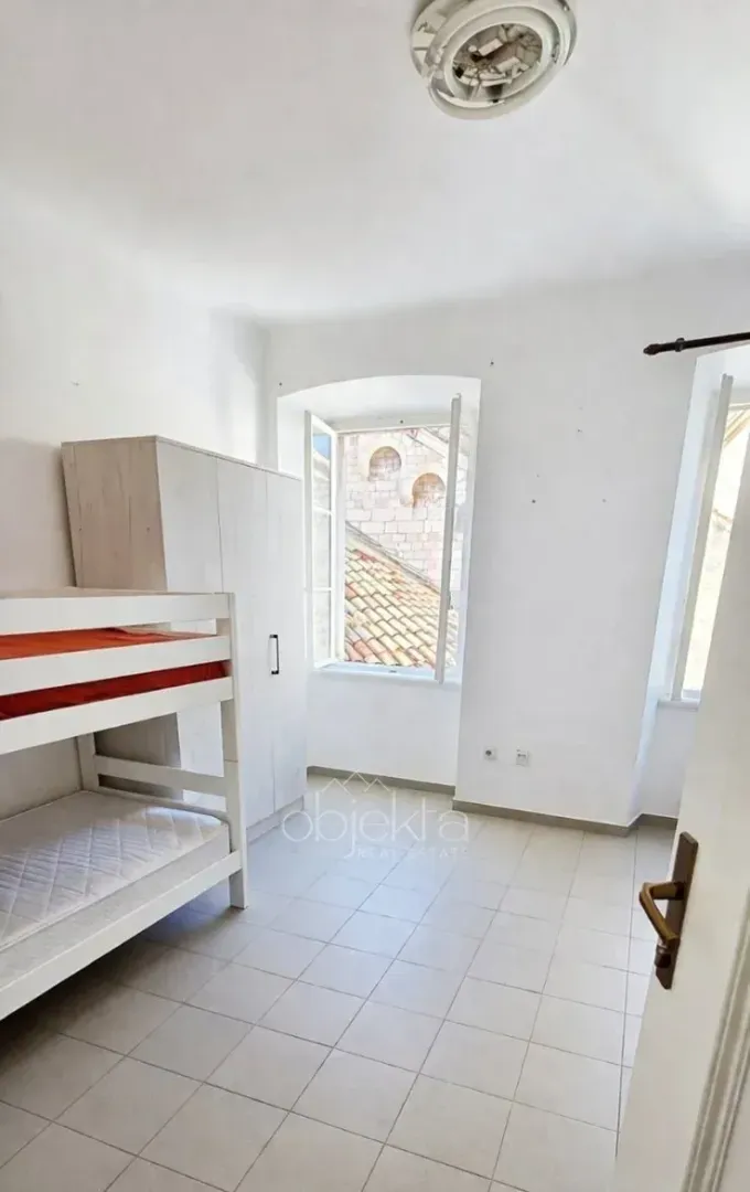Small bedroom with a bunk bed and a wardrobe.