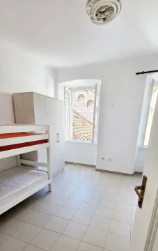 Small bedroom with a bunk bed and a wardrobe. - image 11
