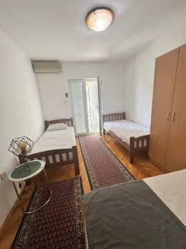 Bedroom with three single beds, a wardrobe, and access to the terrace. - image 10