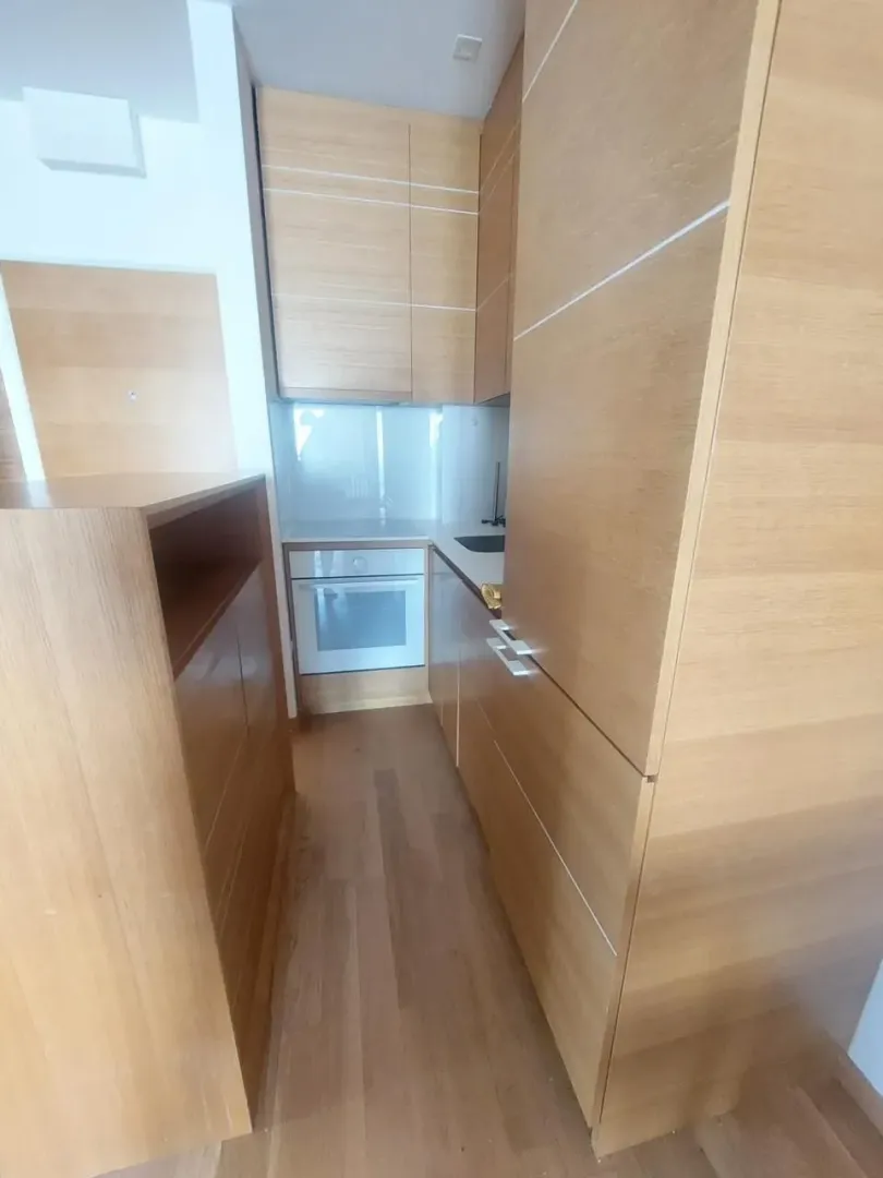 Small modern kitchen with wooden units.