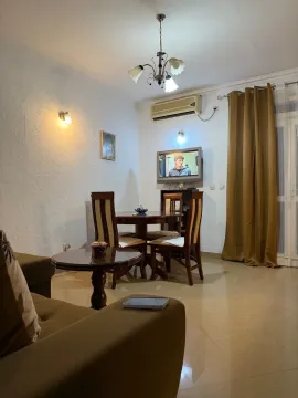 Living room with sofa set, dining table, and TV. - image 2