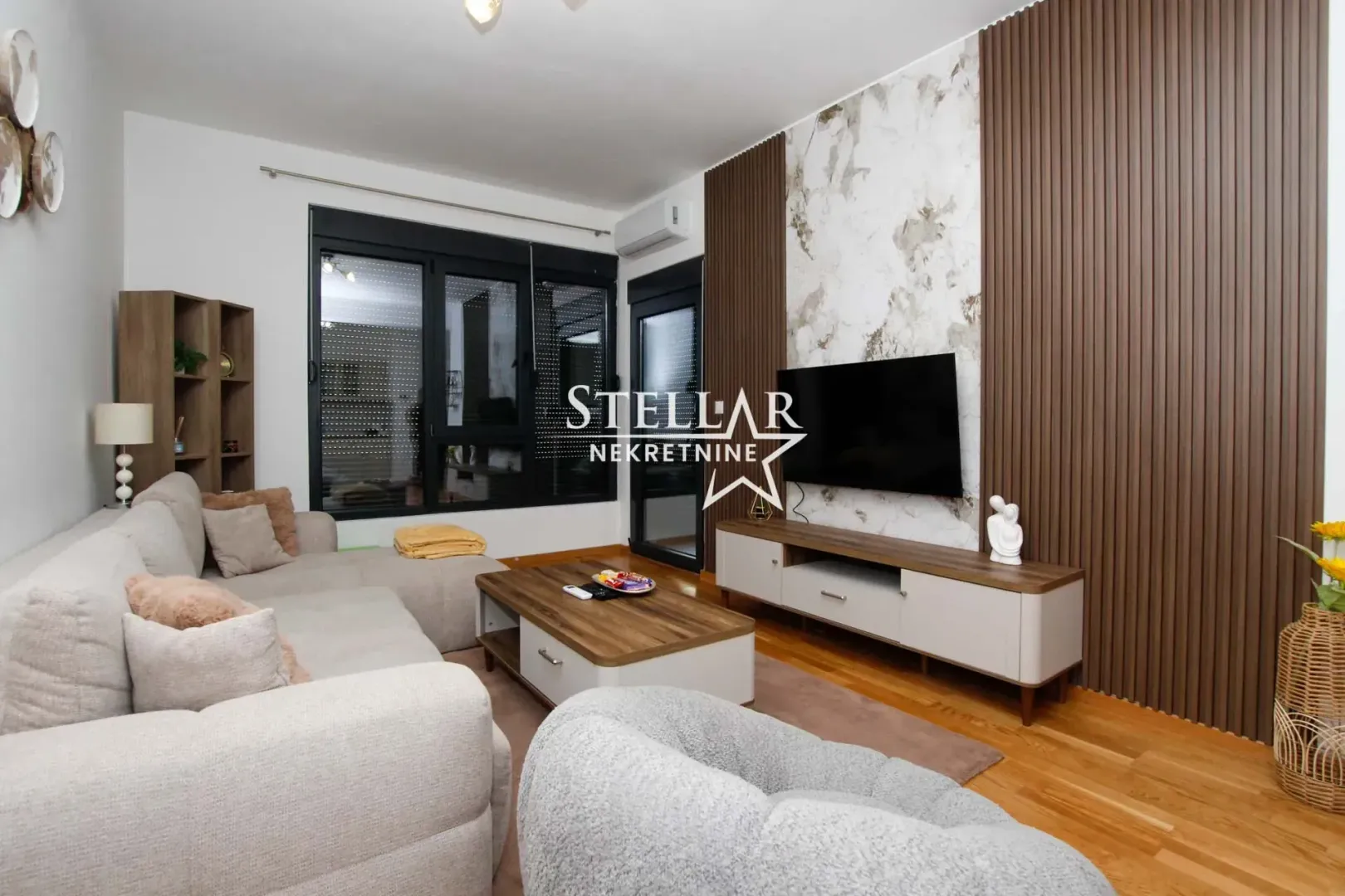 Living room with a sofa, coffee table, and TV unit.