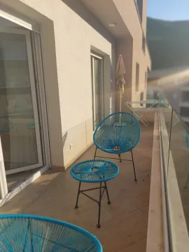 Spacious terrace with patio furniture and surrounding view. - image 10