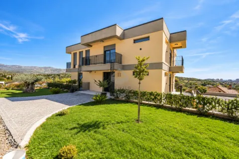 Exterior view of a two-story house with a landscaped yard and surrounding views. - image 3