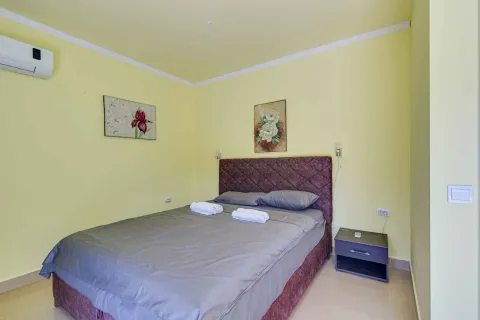 Spavaća soba sa bračnim krevetom, žutim zidovima i klima uređajem. - image 37