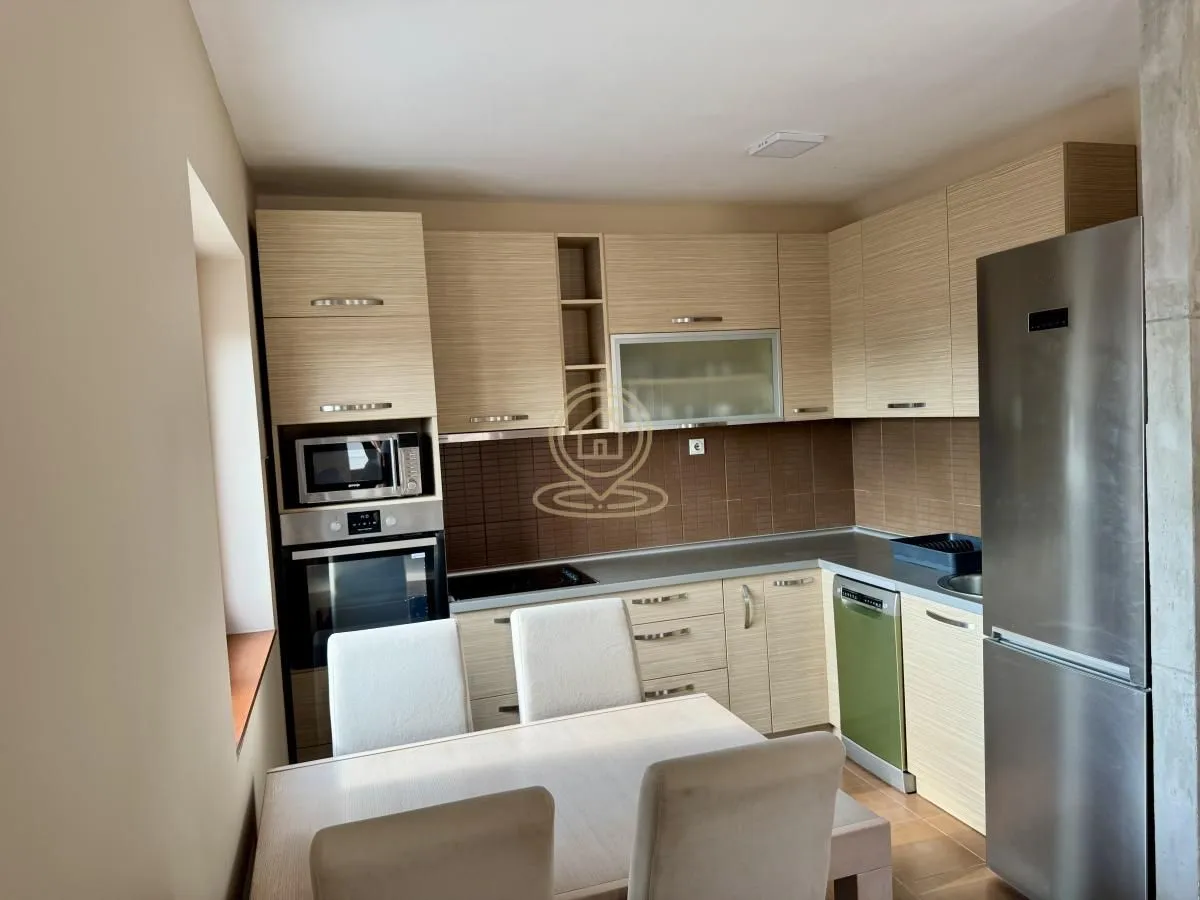 Kitchen with wooden cabinetry and a dining table.