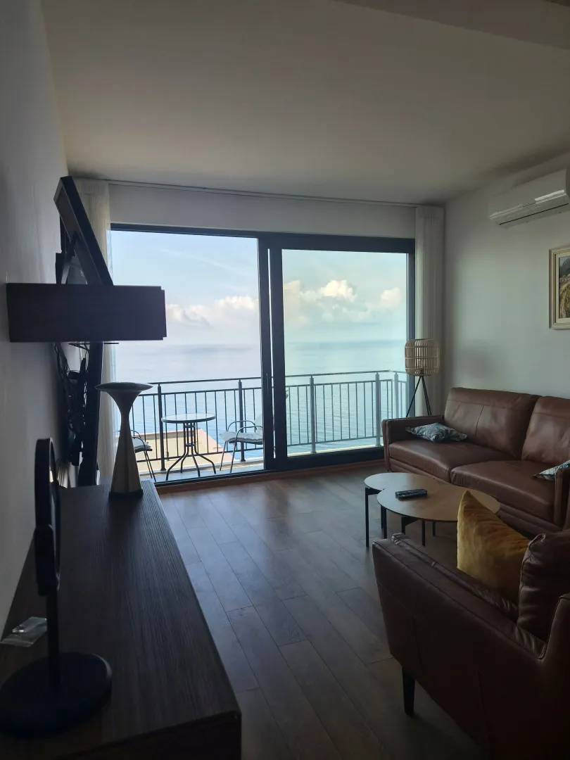 Living room with furniture and a sea view.