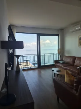 Living room with furniture and a sea view. - image 7