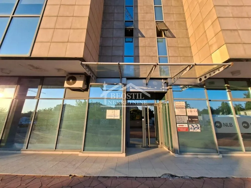 Entrance to a commercial building with a glass facade.