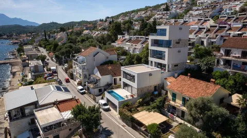 Aerial view of properties near the coast and the hilly landscape. - image 6
