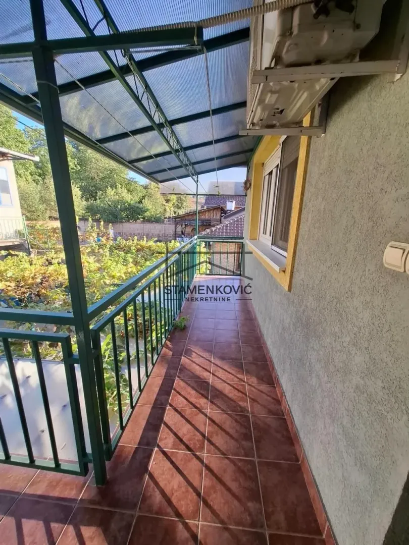 Covered balcony space with ceramic tiles and a view of the courtyard.