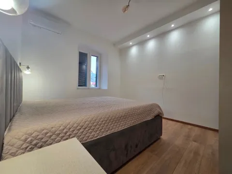 Modern bedroom with a double bed and wooden flooring. - image 9