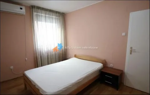 Bedroom with a double bed, nightstand, and air conditioning. - image 15