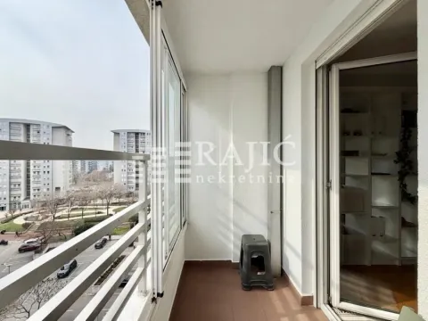 Glazed balcony with a city view. - image 13