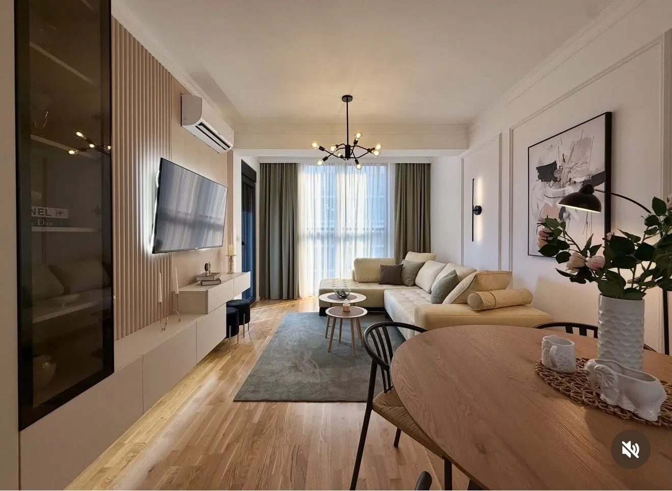 Modern and bright living room with a sofa and dining table.