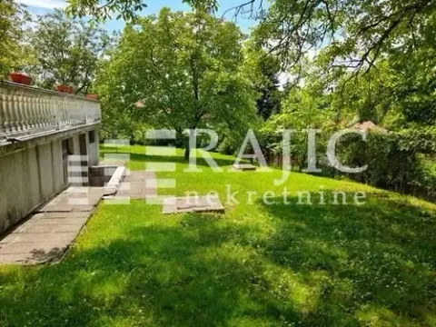 Green yard with a terrace and surrounding vegetation. - image 7