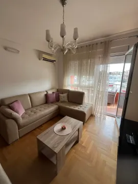 Living room with a sectional sofa, coffee table, and access to the terrace. - image 3
