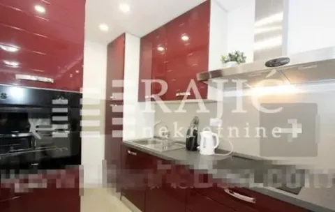 Modern kitchen with red cabinetry and built-in appliances. - image 5