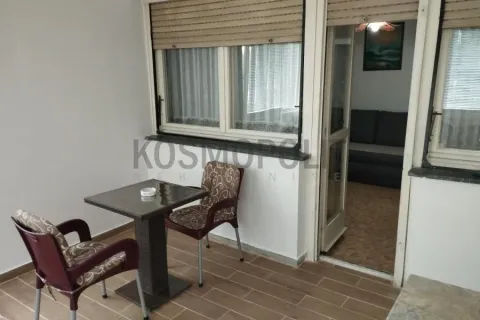 Covered terrace with a table and chairs, looking inside. - image 5
