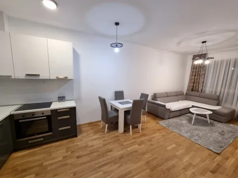 Open-plan living room with kitchen and dining area. - image 2