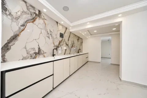 Modern kitchen with white cabinets and marble wall cladding. - image 13