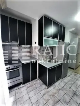 Modern kitchen with black cabinetry and a white countertop. - image 4