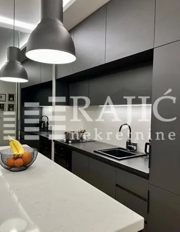 Modern kitchen with dark cabinets and an island.