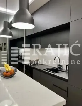 Modern kitchen with dark cabinets and an island. - image 7