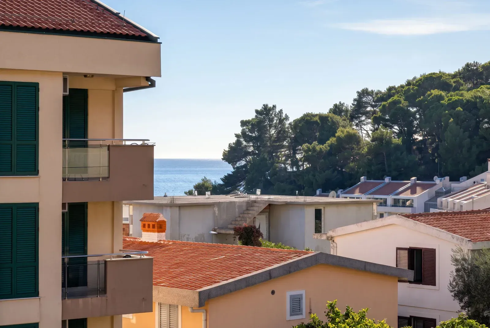 View from the terrace towards surrounding buildings and the sea.