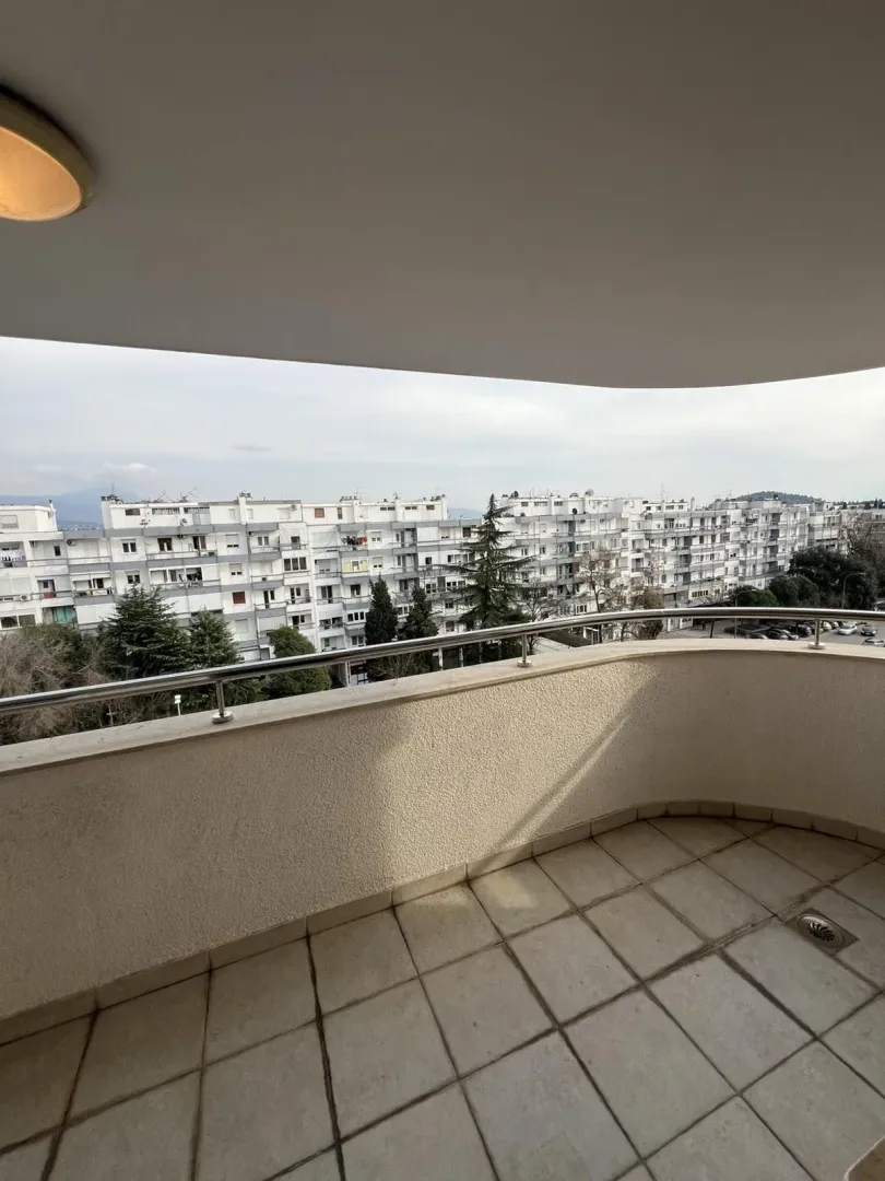 Spacious terrace with a view of surrounding buildings.