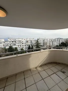 Spacious terrace with a view of surrounding buildings. - image 13