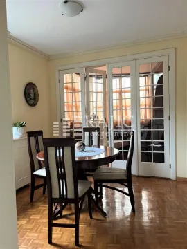 Dining room with wooden table, chairs, and parquet flooring. - image 9