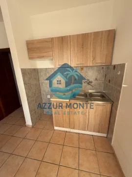 Smaller kitchen with wooden cabinets and a sink. - image 4