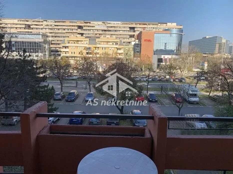 Pogled sa terase na parking i okolne zgrade.