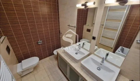Modern bathroom with two sinks, toilet, bidet, and mirror. - image 5
