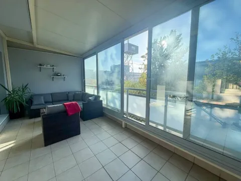 Enclosed terrace with seating furniture and a view of the surroundings. - image 9