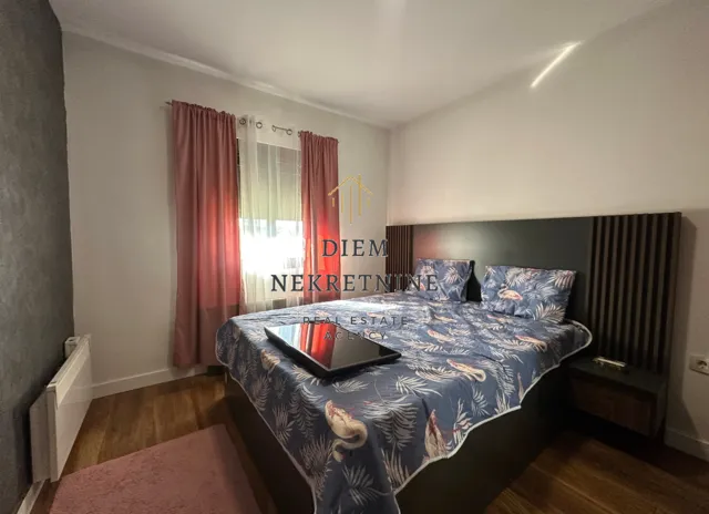 Furnished bedroom with a double bed.