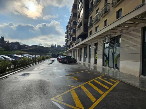 Exterior view of a residential building with parking and access. - image 6
