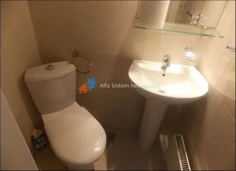 Smaller bathroom with a toilet, washbasin, and mirror. - image 23